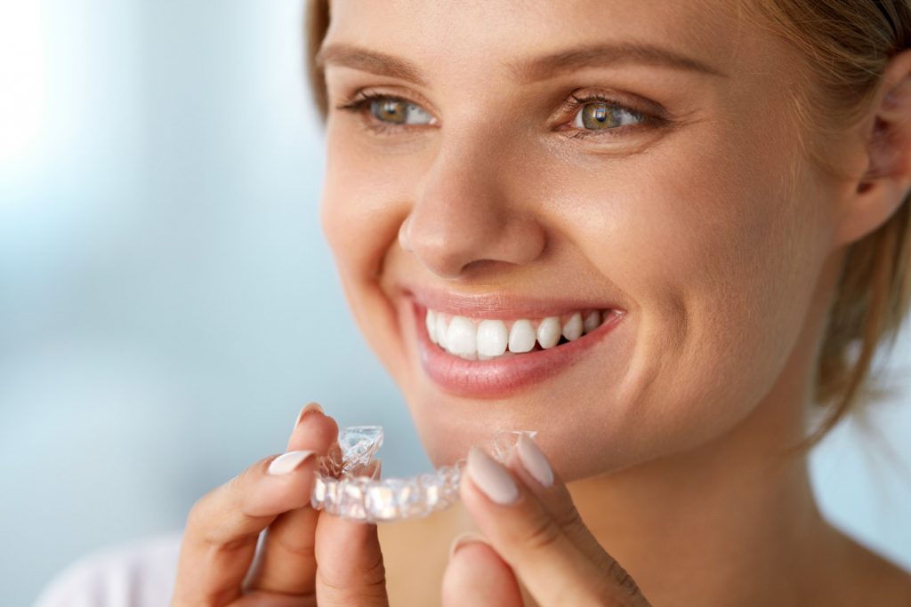 women with Invisalign