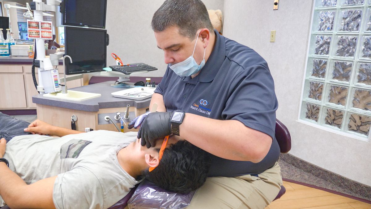 Dr. Clauss working on a patient's teeth